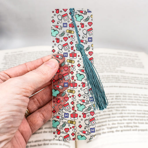 a person is holding a bookmark in their hand