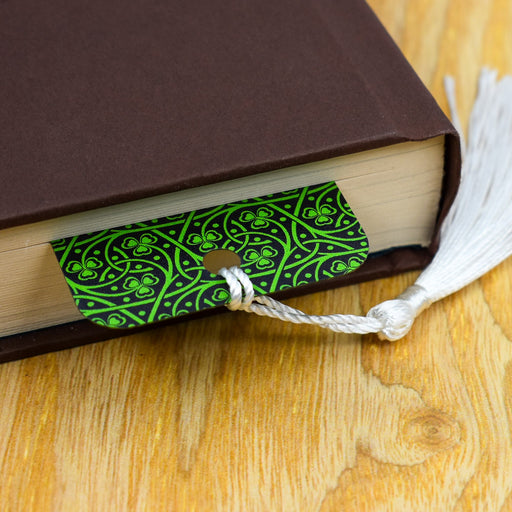 a book with a green cover and a tassel on top of it
