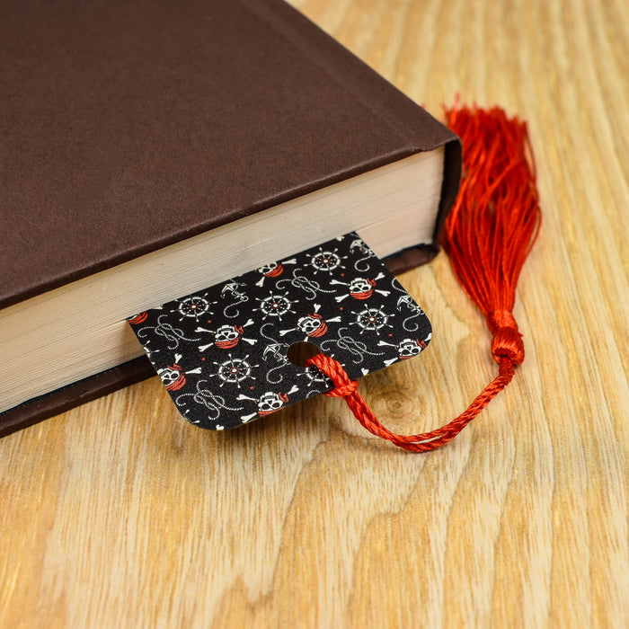 a book with a red tassel on top of it