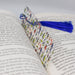 an open book with a tassel on top of it