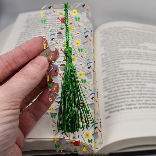 a person is holding a book with a tassel on it