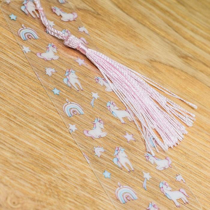 a pink tassel with unicorns and stars on it