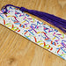 a birthday decoration on a wooden table with a purple tassel