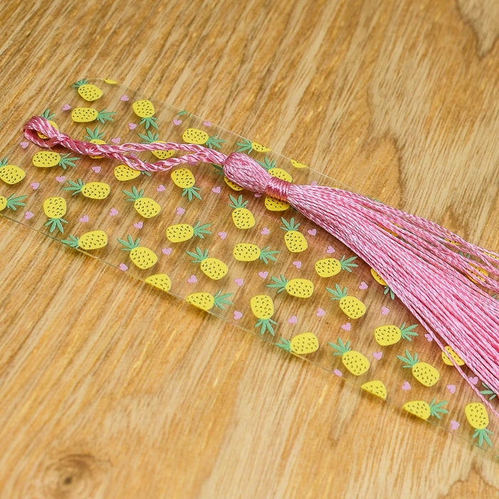a piece of pink and yellow string with pineapples on it