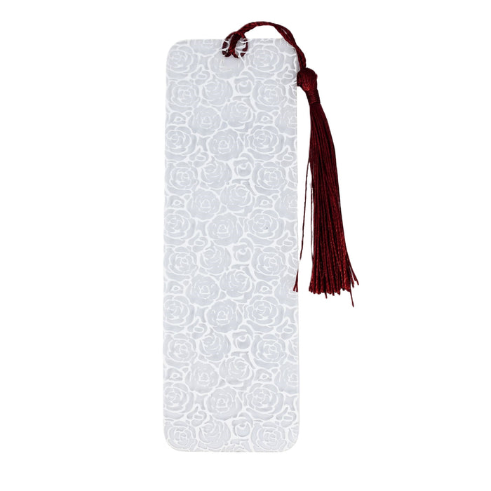 a white bookmark with a tassel hanging from it
