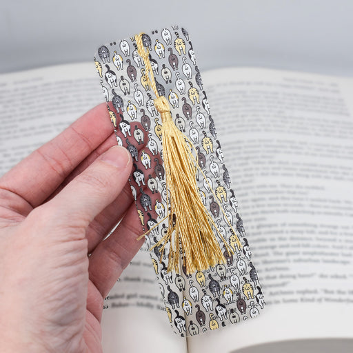 a person holding a book with a tassel on top of it