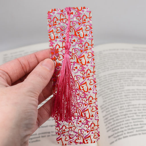 a person is holding a bookmark in their hand