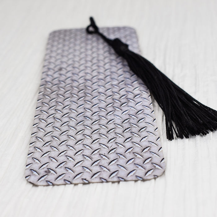 a tie laying on a bed with a tassel