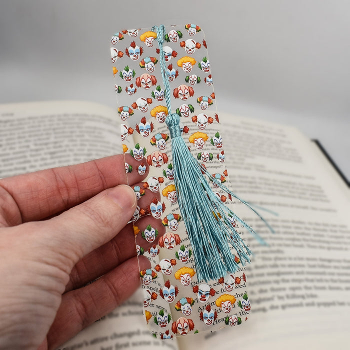 a hand holding a bookmark made out of paper