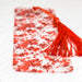 a piece of red and white paper with a tassel