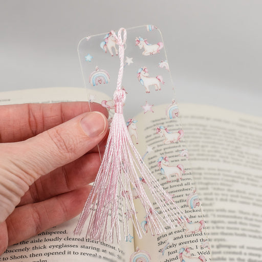 a person is holding a bookmark in their hand