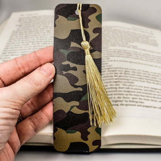 a person holding a bookmark with a tassel