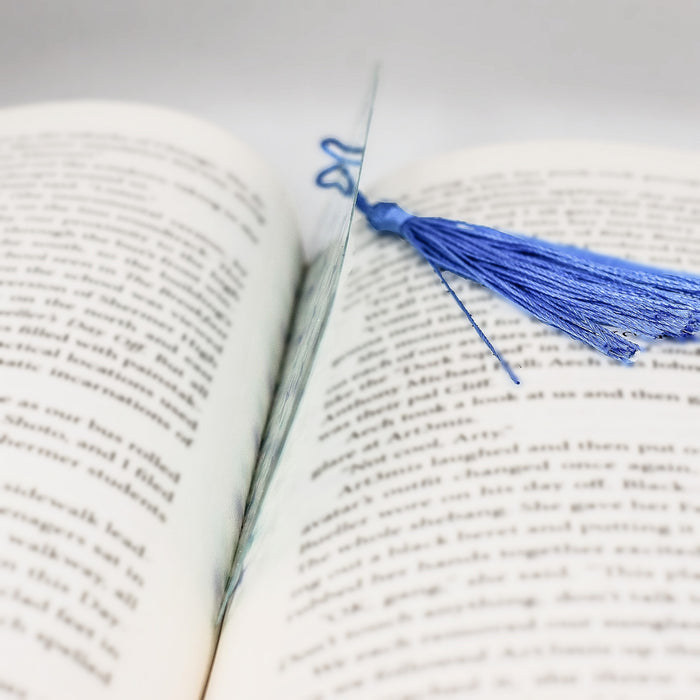 a book with a blue tassel on top of it