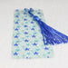 a bookmark with a blue tassel on top of it