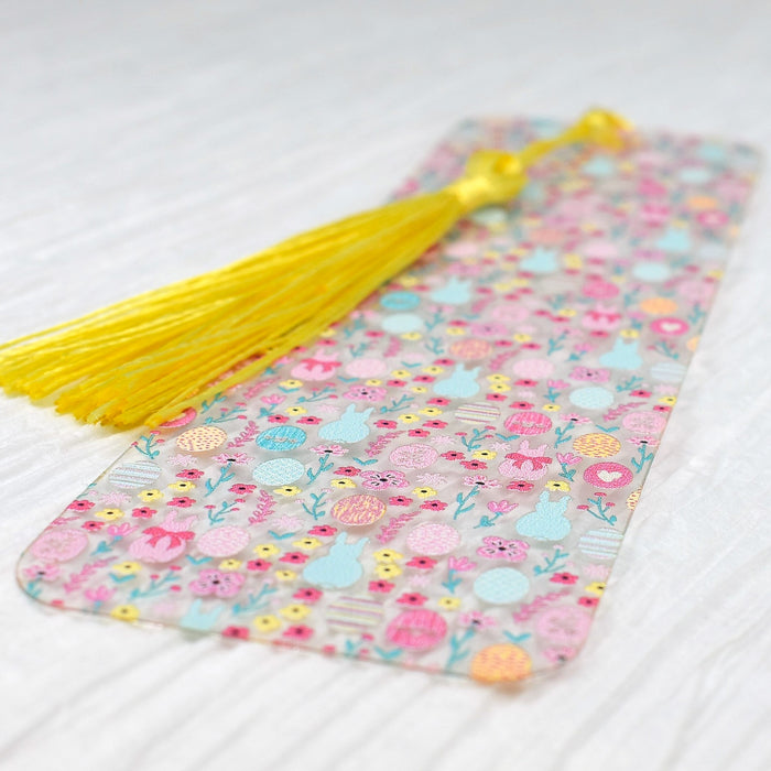 a bookmark with a yellow tassel on top of it