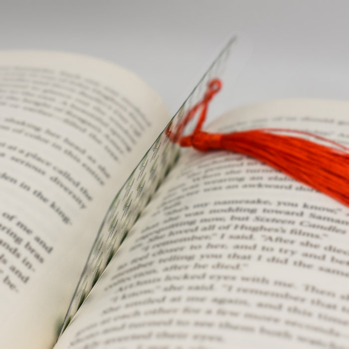 a close up of a book with a red thread