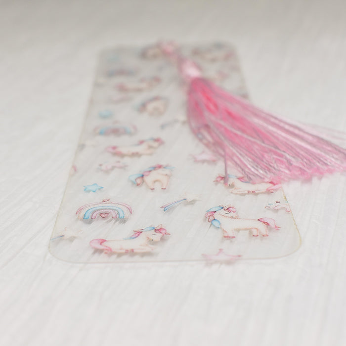 a pink tassel on top of a white sheet