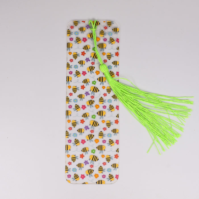a bookmark with a green tassel and a yellow tassel