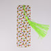a bookmark with a green tassel and a yellow tassel