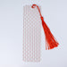 a piece of red string with a tassel