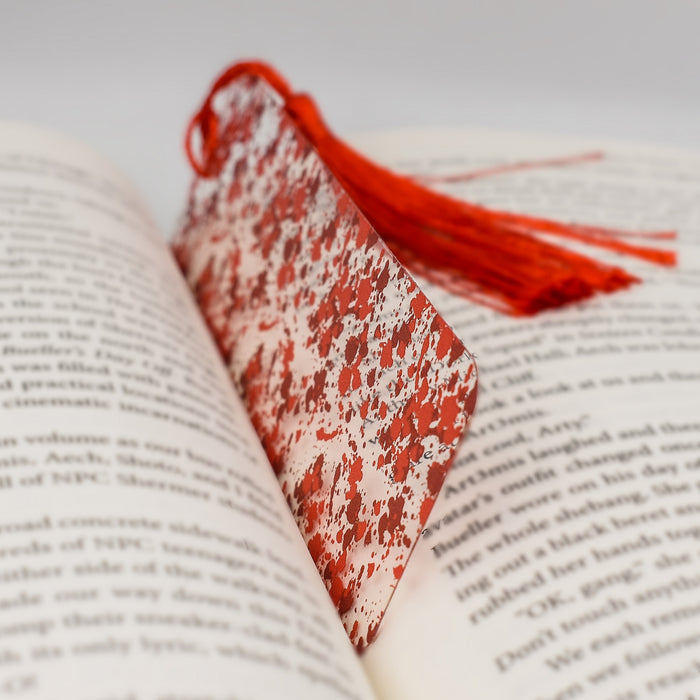 an open book with a red tassel on top of it