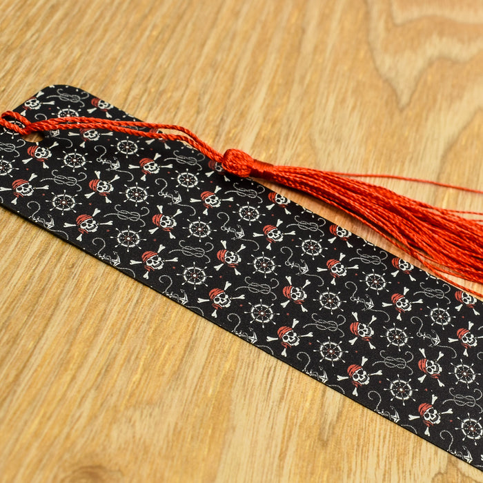 a black tie with a red tassel on a wooden table