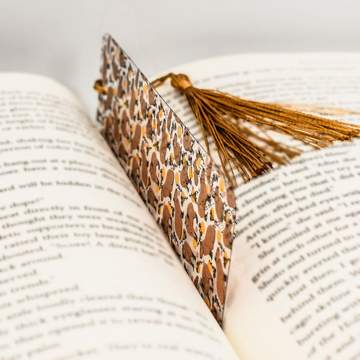 an open book with a tassel on top of it