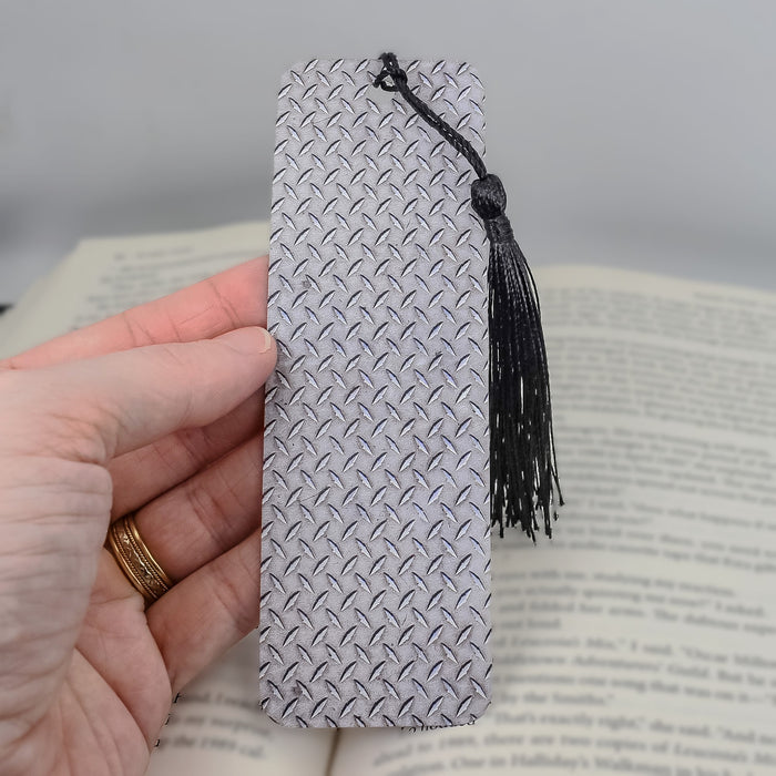 a person is holding a book with a tassel