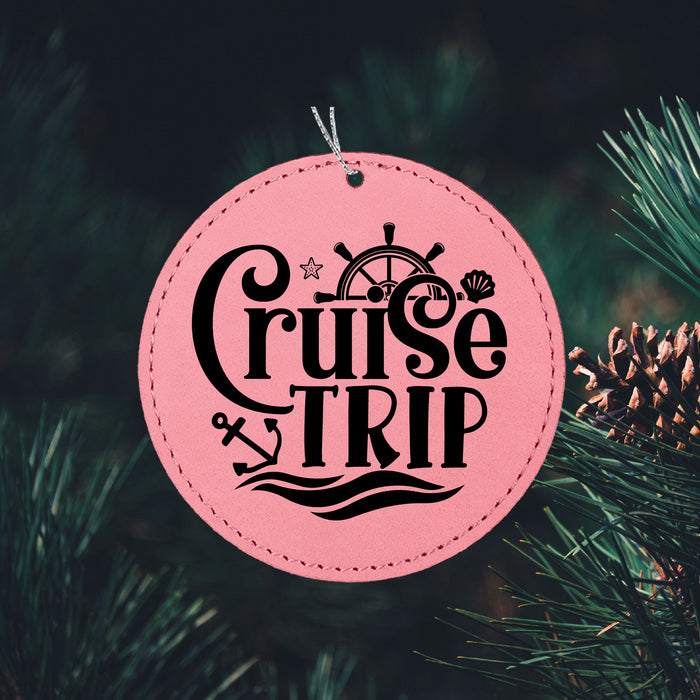 a pink cruise trip ornament hanging from a christmas tree