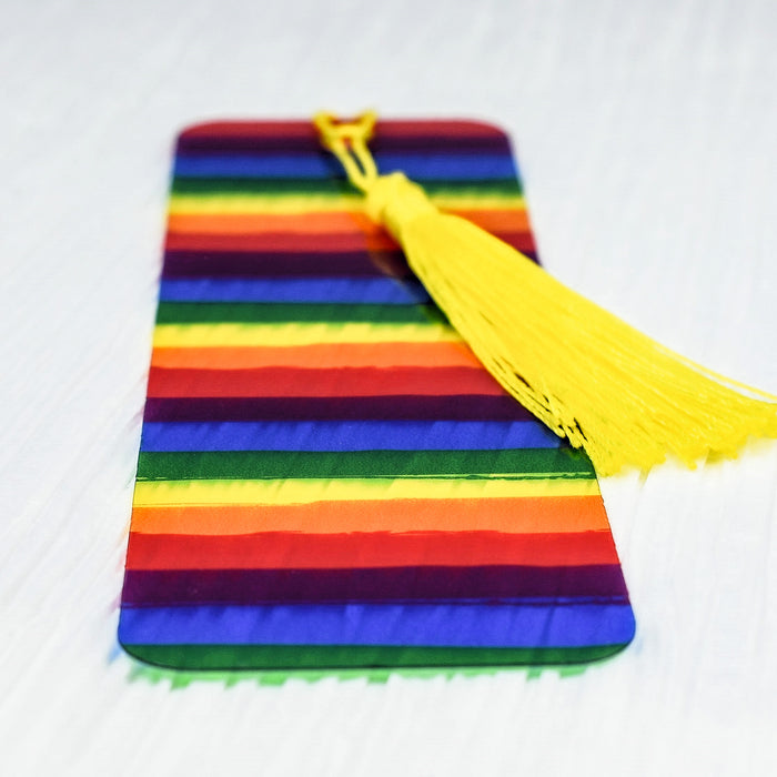 a rainbow colored case with a tassel on top of it