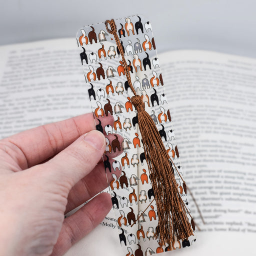 a person holding a bookmark with dogs on it