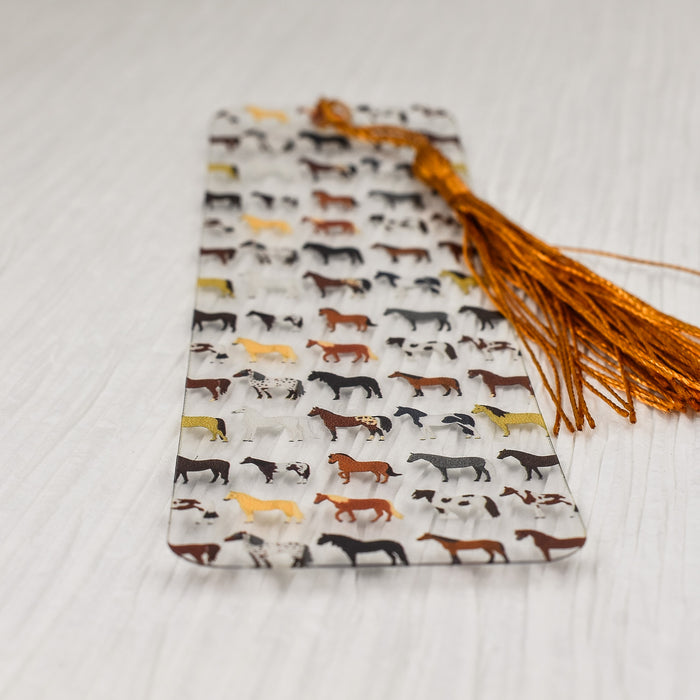 a bookmark with a pattern of horses on it