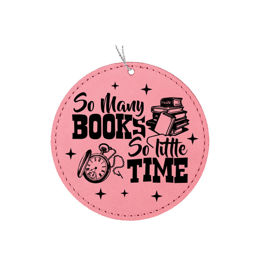 a pink round ornament with a picture of books and a clock