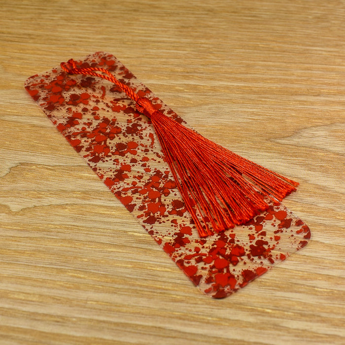 a wooden table with a red tassel on top of it