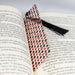 an open book with a tie on top of it