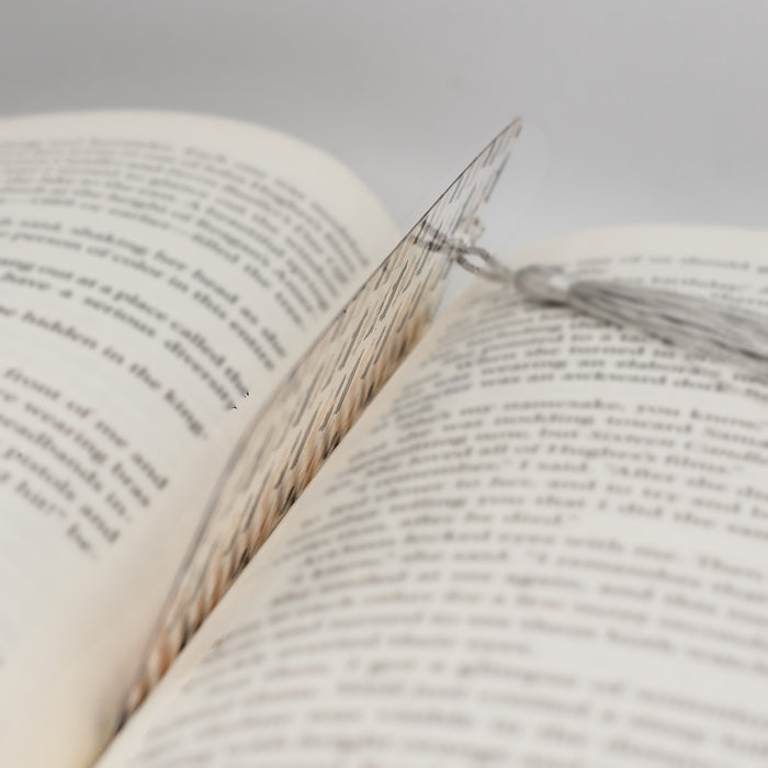 a close up of an open book with a thread on it