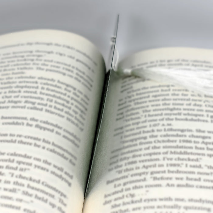 a close up of an open book with a pair of scissors