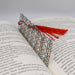 an open book with a red tassel on top of it