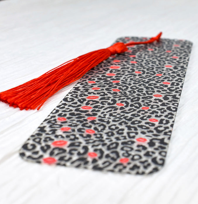 a black and white tie with a red tassel