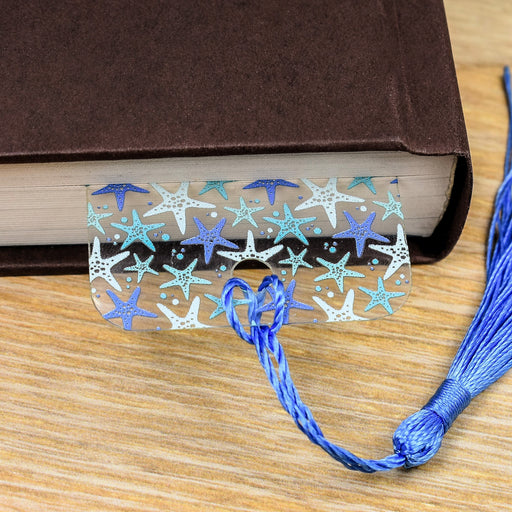 a book with a bookmark and a tassel on a table