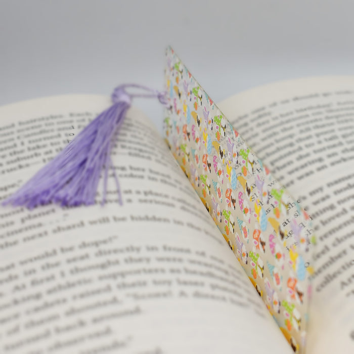 an open book with a tassel on top of it