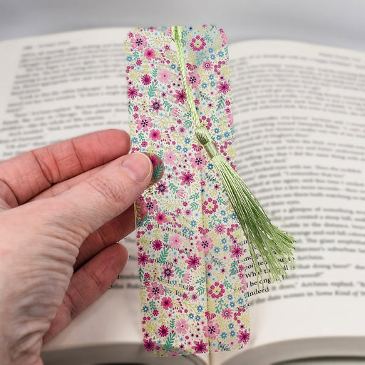 a person is holding a bookmark in their hand