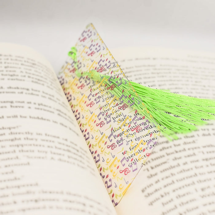 a book with a green tassel on top of it
