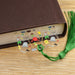 a book with a green tassel on top of it