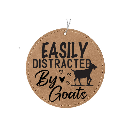 a leather ornament that says easily distracted by goats