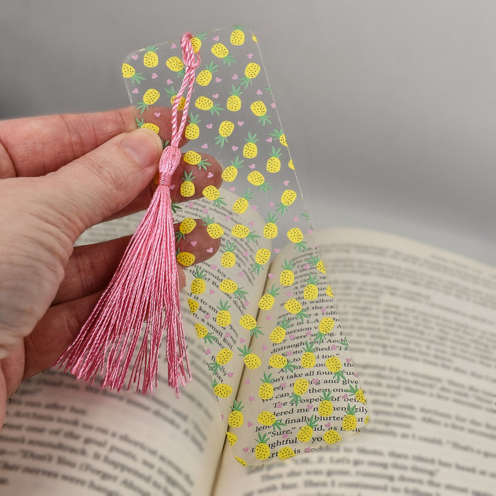 a person is holding a bookmark in their hand