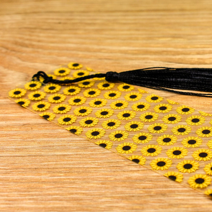 a yellow and black tie with a black tassel