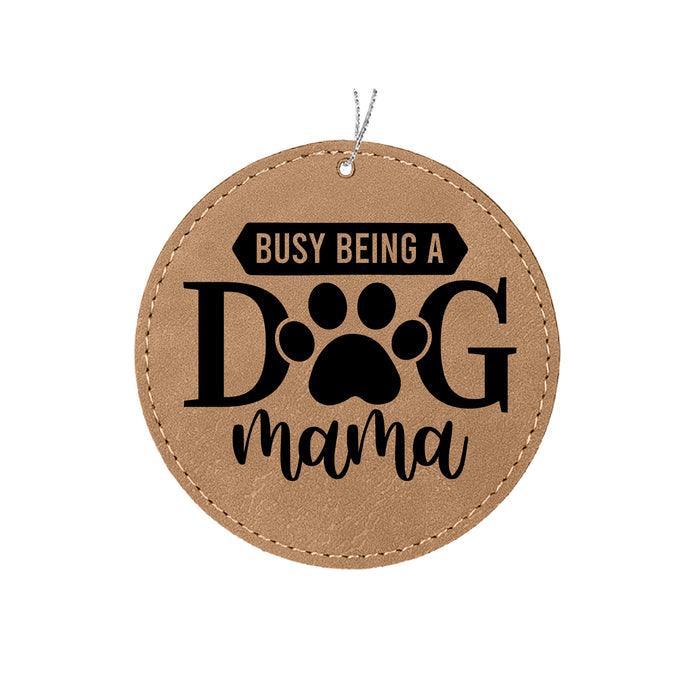 a leather ornament that says, busy being a dog mama