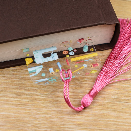 a book with a pink tassel and a pair of scissors
