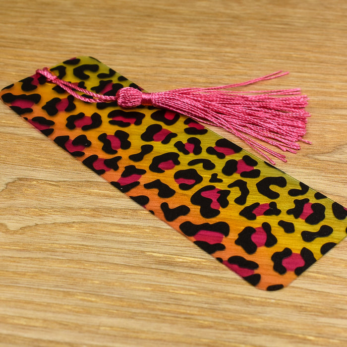 a bookmark with a tassel on top of a wooden table